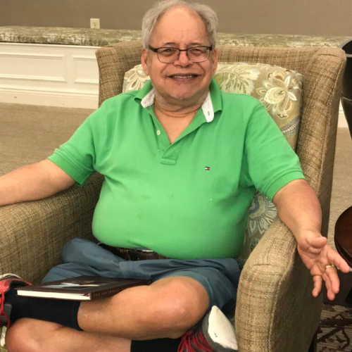 Howard Dyner is pictured sitting in an armchair. He and his mother Elaine are both residents of Paul's Run Senior Community