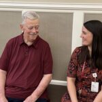 Gerry sits with Pastor Michelle on a bench in Paul's Run Retirement Community in northeast Philadelphia.