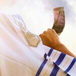 Jewish man blows the Shofar of Rosh Hashanah