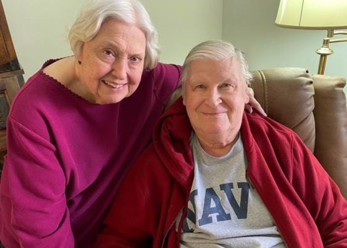 Couple smiles while sitting in their Independent Living apartment at Paul's Run