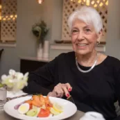 A Paul's Run resident enjoys her fresh vegetables and healthy meals in the dining room.