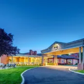 The front face of Paul's Run Retirement community in twilight.