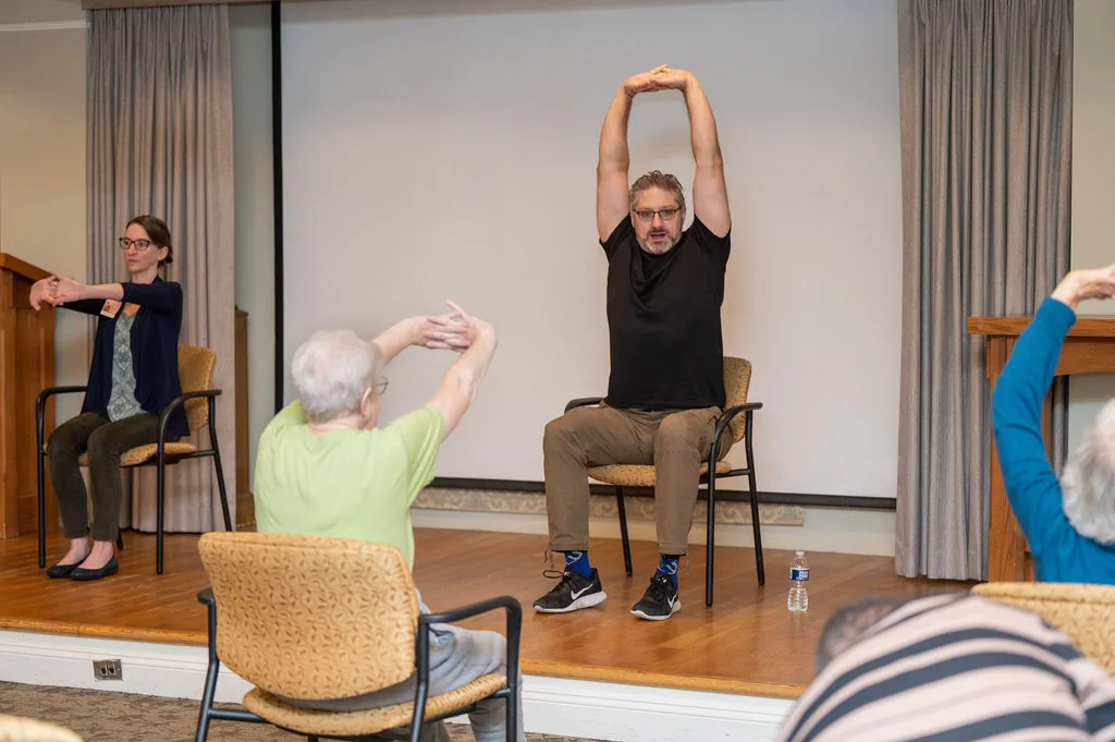 Pauls Run Wellness Director leads residents through stretches